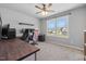 Well-lit bedroom featuring carpet, ceiling fan, and large window overlooking the neighborhood at 38 Winter Red Way, Benson, NC 27504