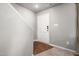 Bright entryway featuring neutral paint, hardwood floors transitioning to carpet, and a secure front door at 38 Winter Red Way, Benson, NC 27504