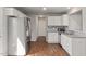 Modern kitchen with white cabinets, stainless steel appliances, granite counters, and hardwood floors at 38 Winter Red Way, Benson, NC 27504