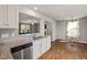 Bright kitchen featuring granite countertops, stainless steel dishwasher, and a view into the living area at 38 Winter Red Way, Benson, NC 27504