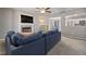 Cozy living room with a fireplace, a ceiling fan, and a glimpse into the dining and kitchen areas at 38 Winter Red Way, Benson, NC 27504