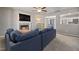 Cozy living room with a fireplace, a ceiling fan, and a glimpse into the dining and kitchen areas at 38 Winter Red Way, Benson, NC 27504