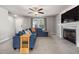 Comfortable living room boasts a fireplace, plush blue sofa, and an abundance of natural light at 38 Winter Red Way, Benson, NC 27504
