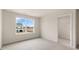 A bright, carpeted bedroom with a large window and a walk-in closet at 42 Sweet Meadow Rd, Angier, NC 27501