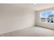 Bright, carpeted bedroom with a large window overlooking the property's exterior at 42 Sweet Meadow Rd, Angier, NC 27501