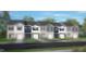 New townhome exterior with gray siding, white trim, and a one car garage at 42 Sweet Meadow Rd, Angier, NC 27501