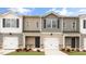 Exterior view of newly built townhomes, featuring neutral siding, and individual garages at 42 Sweet Meadow Rd, Angier, NC 27501