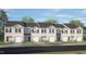 New construction townhomes on a sunny day with well manicured lawns at 42 Sweet Meadow Rd, Angier, NC 27501