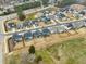 Aerial view of a modern suburban neighborhood, featuring gray houses with fenced yards, well-kept lawns, and orderly streets at 4513 Bridle Run Dr, Raleigh, NC 27606