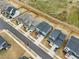 Aerial view captures a vibrant neighborhood with modern homes, manicured lawns, and tree-lined streets at 4513 Bridle Run Dr, Raleigh, NC 27606