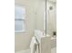 Bathroom showing a glass enclosed shower and neutral colored tile at 4513 Bridle Run Dr, Raleigh, NC 27606