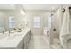Bathroom featuring double sink vanity, glass enclosed shower, and neutral finishes at 4513 Bridle Run Dr, Raleigh, NC 27606