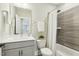 This bathroom boasts a modern vanity, decorative tile, and shower and tub combination at 4513 Bridle Run Dr, Raleigh, NC 27606