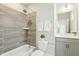This bathroom features a shower/tub combo with a shower head, a white sink and a white toilet at 4513 Bridle Run Dr, Raleigh, NC 27606