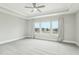 Serene primary bedroom featuring a tray ceiling and large windows with curtains at 4513 Bridle Run Dr, Raleigh, NC 27606