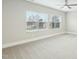 Bright bedroom with neutral carpet, ceiling fan, and large windows at 4513 Bridle Run Dr, Raleigh, NC 27606