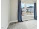 Cozy bedroom with large windows and gray carpet with blue curtain at 4513 Bridle Run Dr, Raleigh, NC 27606