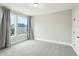 This neutral bedroom features carpet, two windows and white trim at 4513 Bridle Run Dr, Raleigh, NC 27606