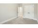 This neutral bedroom features an open doorway, closet and plush carpet at 4513 Bridle Run Dr, Raleigh, NC 27606