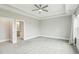 Spacious bedroom with ceiling fan, carpet, and ensuite bathroom at 4513 Bridle Run Dr, Raleigh, NC 27606