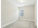 Bedroom features a window and neutral colored carpet at 4513 Bridle Run Dr, Raleigh, NC 27606