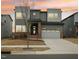 Contemporary two-story home featuring a brick facade, large windows, and an attached two-car garage at 4513 Bridle Run Dr, Raleigh, NC 27606