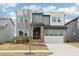 Modern two-story home featuring a two-car garage, neutral siding, and brick accents at 4513 Bridle Run Dr, Raleigh, NC 27606