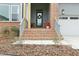 Inviting front porch with brick steps, a front door wreath and a well manicured landscape at 4513 Bridle Run Dr, Raleigh, NC 27606