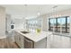 Modern kitchen island with white countertop, a stainless steel sink, and pendant lighting at 4513 Bridle Run Dr, Raleigh, NC 27606