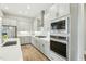 Modern kitchen showcases gray cabinets, stainless steel appliances, and tile backsplash at 4513 Bridle Run Dr, Raleigh, NC 27606