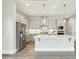 Contemporary kitchen boasts stainless steel appliances, gray cabinetry, and a center island at 4513 Bridle Run Dr, Raleigh, NC 27606