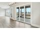Spacious living room offering natural light with door to outside patio, and hardwood flooring at 4513 Bridle Run Dr, Raleigh, NC 27606