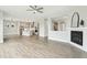 Open-concept living room with a fireplace, luxury vinyl plank flooring, and an adjacent kitchen at 4513 Bridle Run Dr, Raleigh, NC 27606