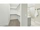 Walk-in closet with built-in shelving adjacent to the ensuite bathroom at 4513 Bridle Run Dr, Raleigh, NC 27606