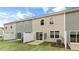 Back view of townhomes showcasing fenced patios, and grassy yards at 46 Sweet Meadow Rd, Angier, NC 27501