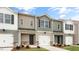 Well-maintained townhomes featuring coordinated colors, individual garages, and landscaped front yards at 46 Sweet Meadow Rd, Angier, NC 27501