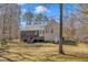 View of the house with a large wooden deck and screened in porch, complemented by a spacious grassy backyard at 484 Galaxy Dr, Garner, NC 27529