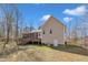 Spacious backyard featuring a tan house with a large wooden deck and screened-in porch, ideal for relaxing or entertaining at 484 Galaxy Dr, Garner, NC 27529