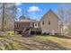 View of the house with a large wooden deck and screened in porch, perfect for outdoor entertaining in a spacious backyard at 484 Galaxy Dr, Garner, NC 27529