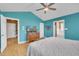 Bedroom featuring an ensuite bathroom, wood flooring, ample space and serene turquoise walls at 484 Galaxy Dr, Garner, NC 27529