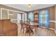 Charming dining room featuring natural wood floors, blue curtains, and a vintage wooden table set at 484 Galaxy Dr, Garner, NC 27529