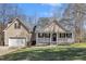 Charming two-story home with front porch and a well-manicured lawn at 484 Galaxy Dr, Garner, NC 27529