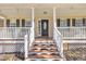 Close up on the front porch with steps and view of front door at 484 Galaxy Dr, Garner, NC 27529