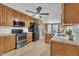 Modern kitchen featuring stainless steel appliances, wood cabinets, and granite countertops at 484 Galaxy Dr, Garner, NC 27529