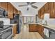 Spacious kitchen with wood cabinets, stainless steel appliances, and an open view to the dining area at 484 Galaxy Dr, Garner, NC 27529