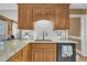 Kitchen sink with granite countertops, subway tile backsplash, and wood cabinets at 484 Galaxy Dr, Garner, NC 27529