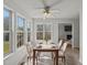 Elegant dining room with a dark wood table, white chairs, and a modern chandelier at 4945 Saulsridge Rd, Raleigh, NC 27603