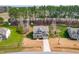 An aerial front view of the two-story home featuring a lawn, long driveway and manicured landscaping at 50 Lockamy Ln, Youngsville, NC 27596