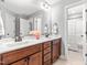 Double vanity bathroom with wood cabinets, large mirror, and access to a shower with curtain at 50 Lockamy Ln, Youngsville, NC 27596