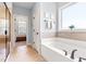 This bathroom features a tub with bronze fixtures and neutral tiling at 50 Lockamy Ln, Youngsville, NC 27596